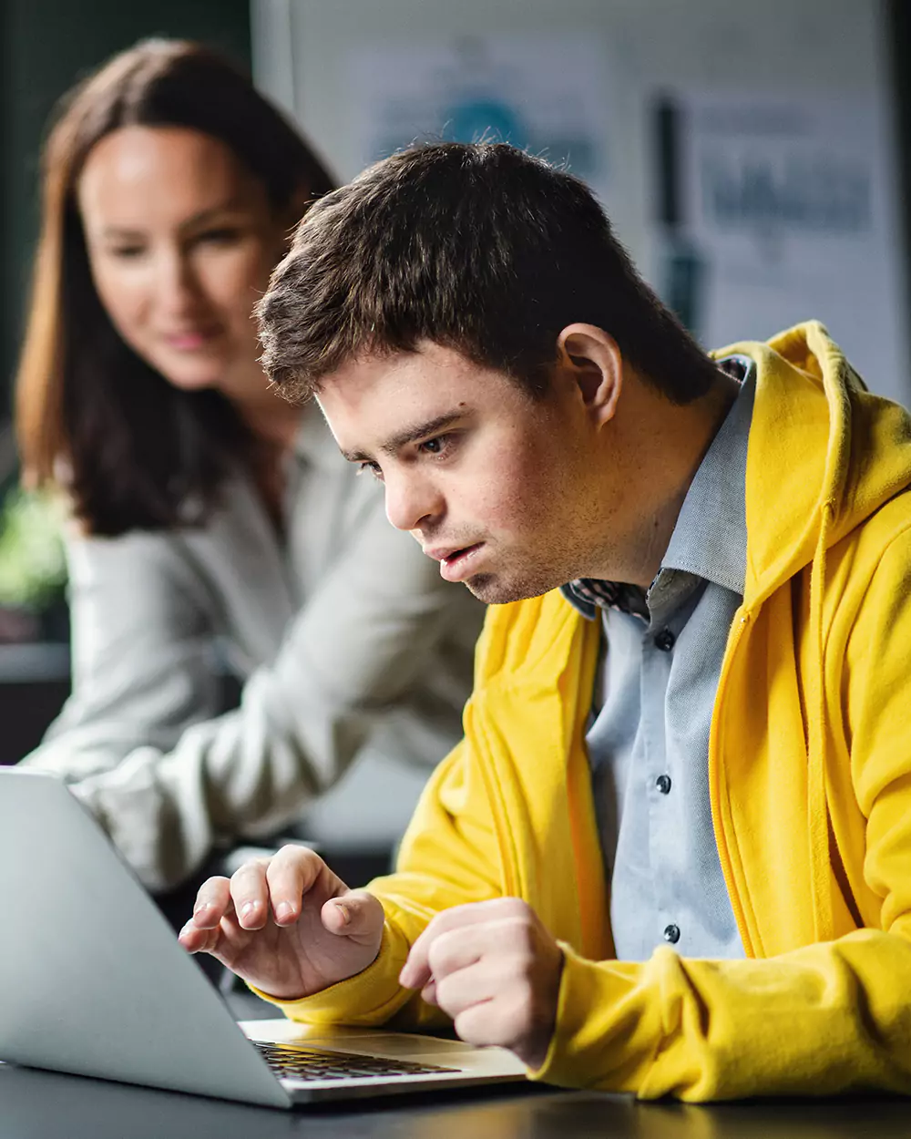 Disabled man with down syndrome using laptop