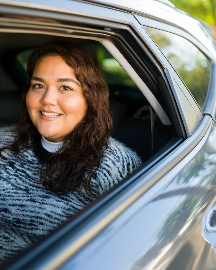 Happy woman in car